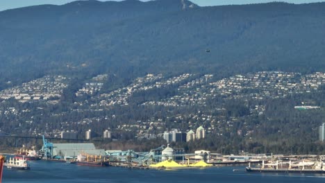 Helicopter-Flying-High-Over-The-Industrial-Terminal-And-City-In-Vancouver,-BC,-Canada