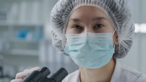 portrait of asian female scientist wearing protective mask in laboratory