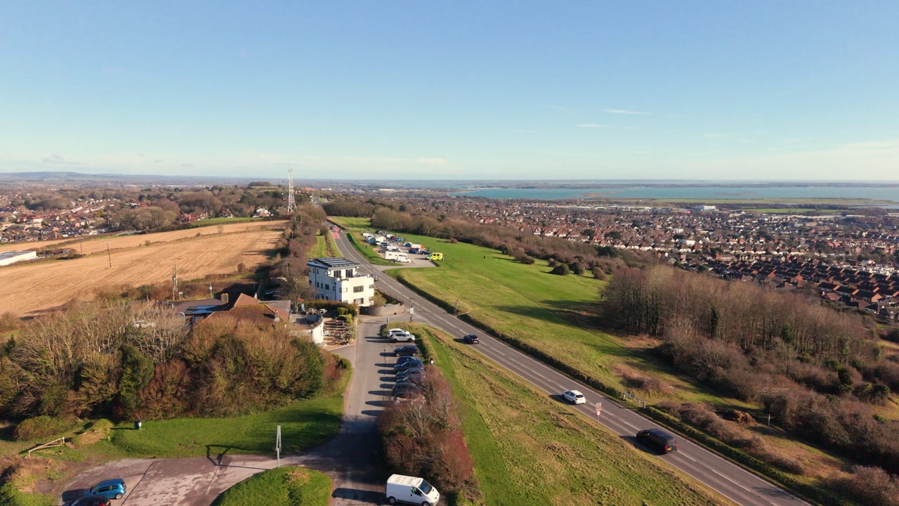 Swanick Hill Portsmouth flight over viewpoint at the top of the hill with views over Portsmouth and across to the Solent on sunny day in late afternoon sun with clear blue sky