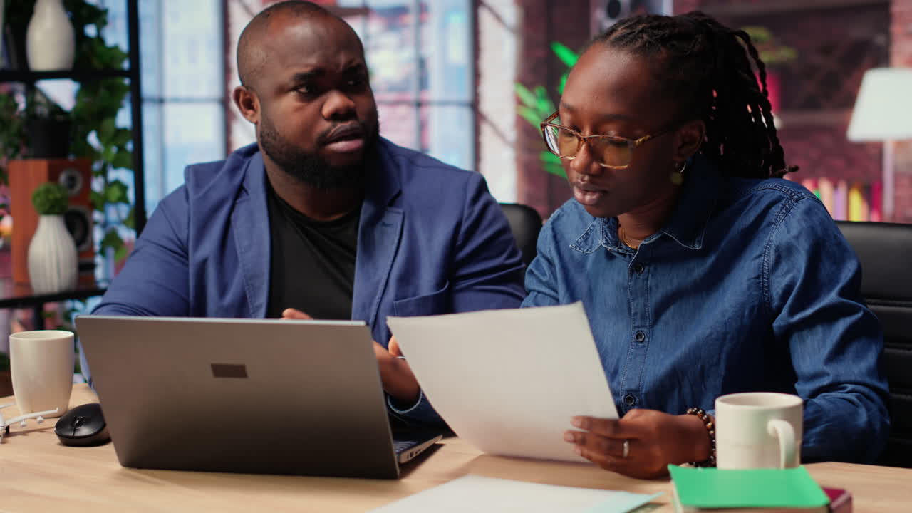 Black people both working from home at their designated office