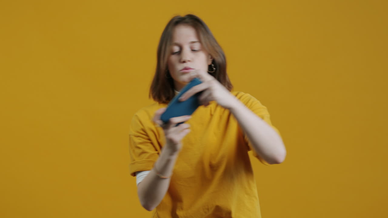 Woman Playing Game on Smartphone