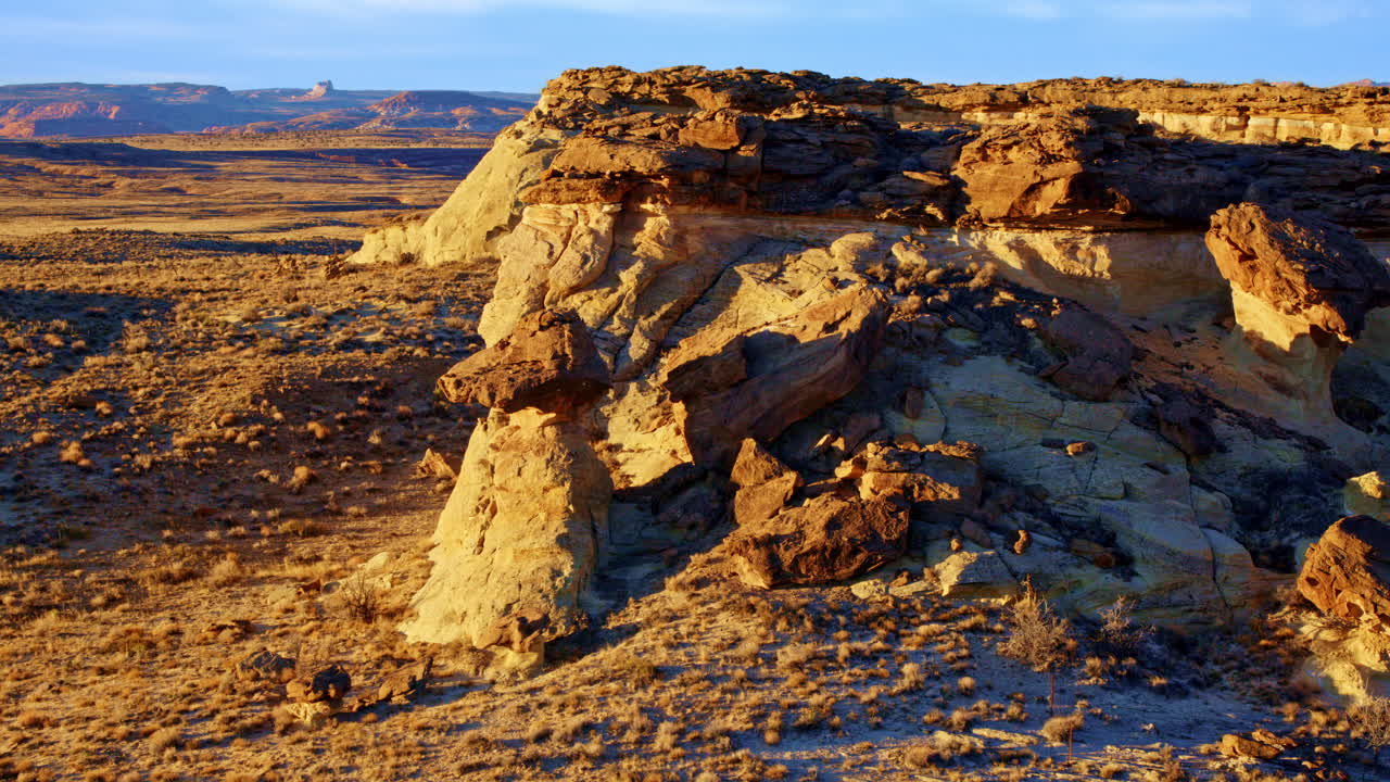 Aerial footage of a drone flying toward fascinating rock formations near Lake Powell in Page, Arizona.
