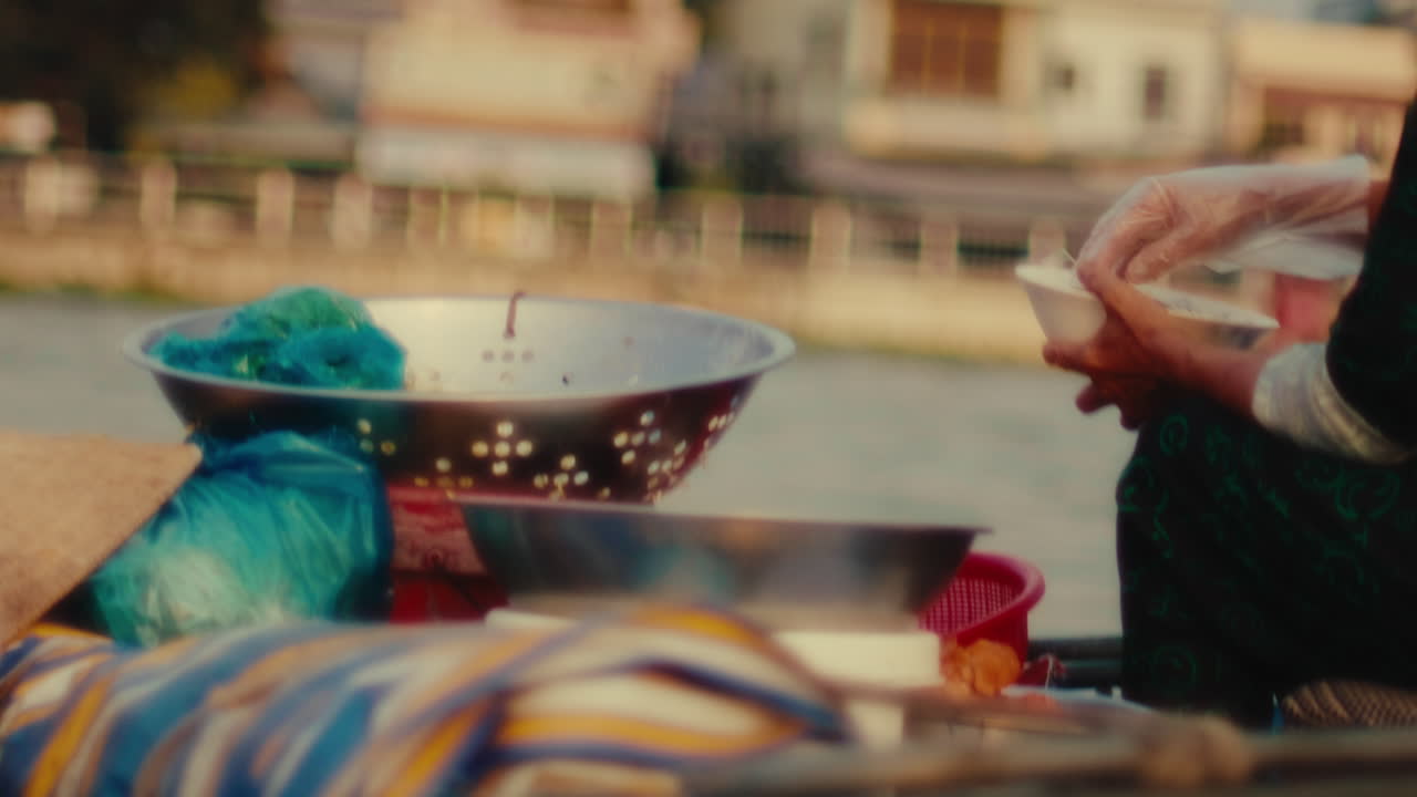 Street Food Vendor Preparing Food on a Boat