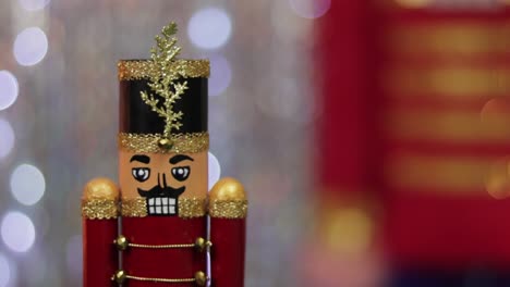 christmas toy soldier nutcracker, same large figurine behind, bokeh