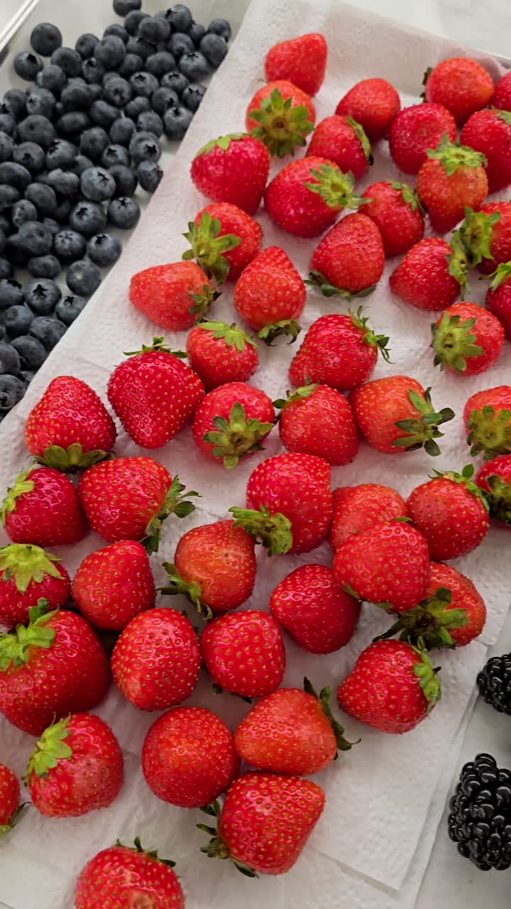 A vibrant collection of berries ready for cake and muffin toppings at a bakery shop.