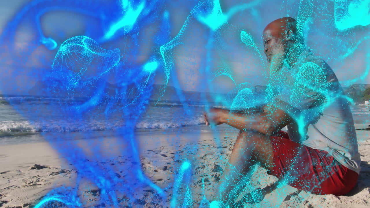 Senior man sitting cross-legged on beach meditating, tech overlay showing drifting cyan particles