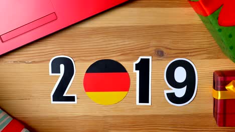 illustration, new year, male hand put on the table on german flag, country ball, 2019