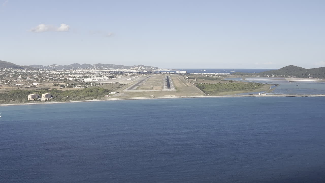Unique pilot’s perspective in a real approach to Ibiza’s airport, Spain. Footage taken from a jet cockpit approaching to the runway in a bright summer afternoon with Ibiza city at the back. 4K 60FPS