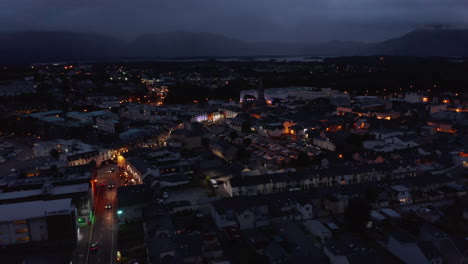 Aerial-panoramic-footage-of-town-centre.-Illuminated-colour-house-facades.-Lake-and-mountains-in-backgrounds.-Killarney,-Ireland