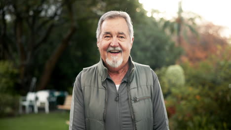 portrait of a smiling older man in a garden