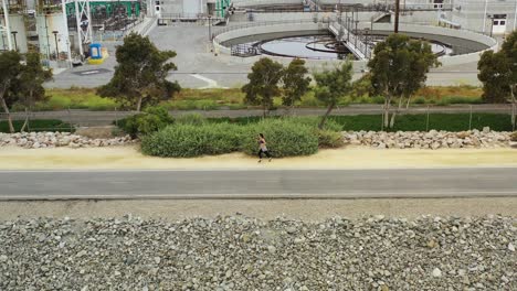 4k-aerial-drone-shot-of-a-woman-out-on-a-morning-jog