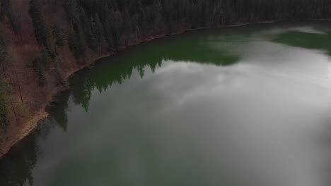 Aerial-view-of-Sfanta-Ana-Lake-in-Romania,-volcanic-lake-with-beautiful-green-water