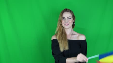 blonde woman waving in front of romanian flag green screen, chroma key background