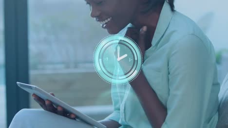 Animation-of-scope-scanning-and-clock-over-african-american-businesswoman-using-tablet