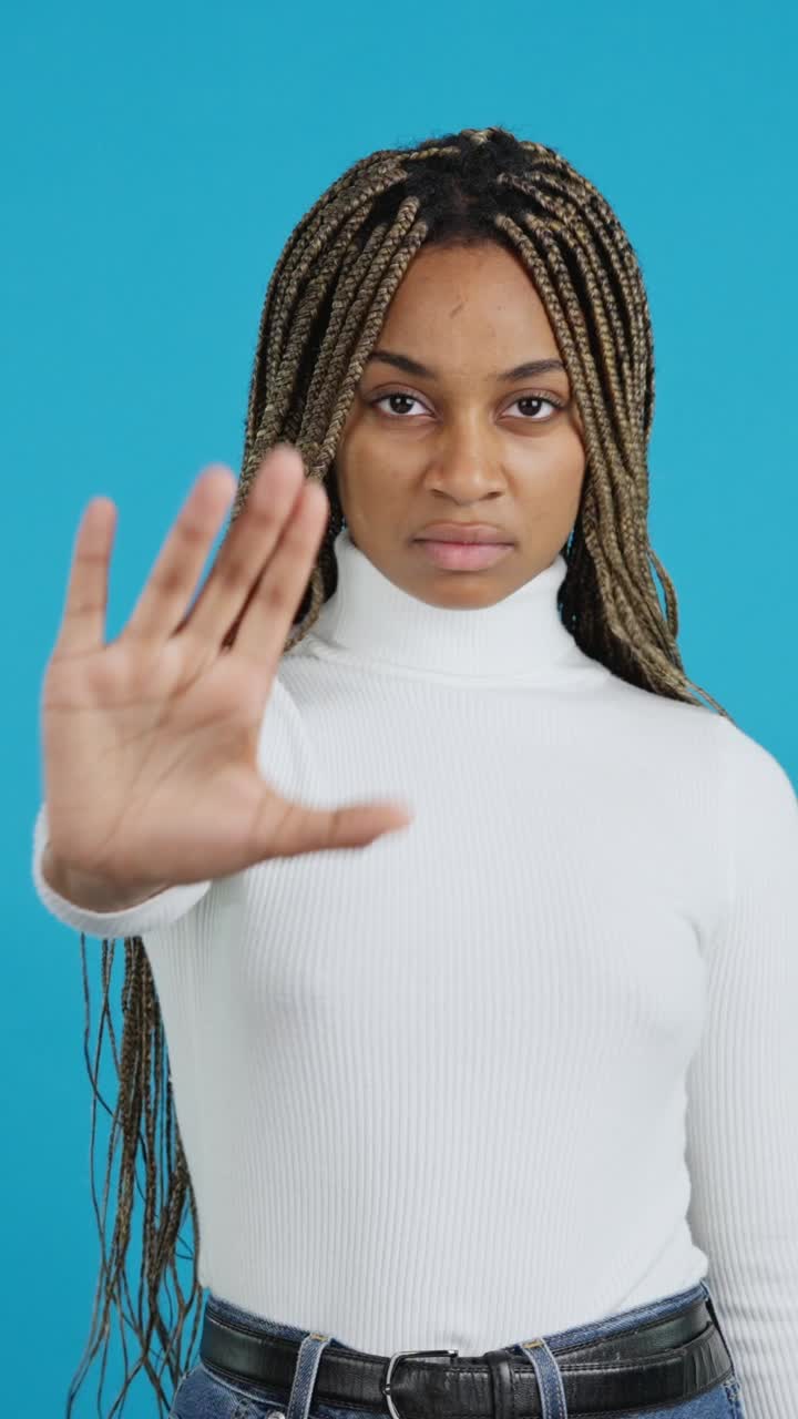 Woman making a stop gesture with a serious expression
