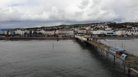 aerial backwards shot of teignmouth pier in devon on a cloudy stormy day