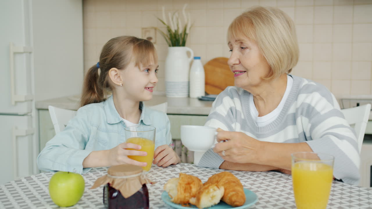 Grandmother and Granddaughter Enjoying Breakfast
