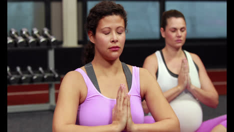 Pregnant-women-doing-yoga-in-fitness-studio