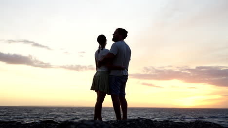 young couple in love look to their future together beyond the sunset