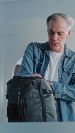 man checking his backpack