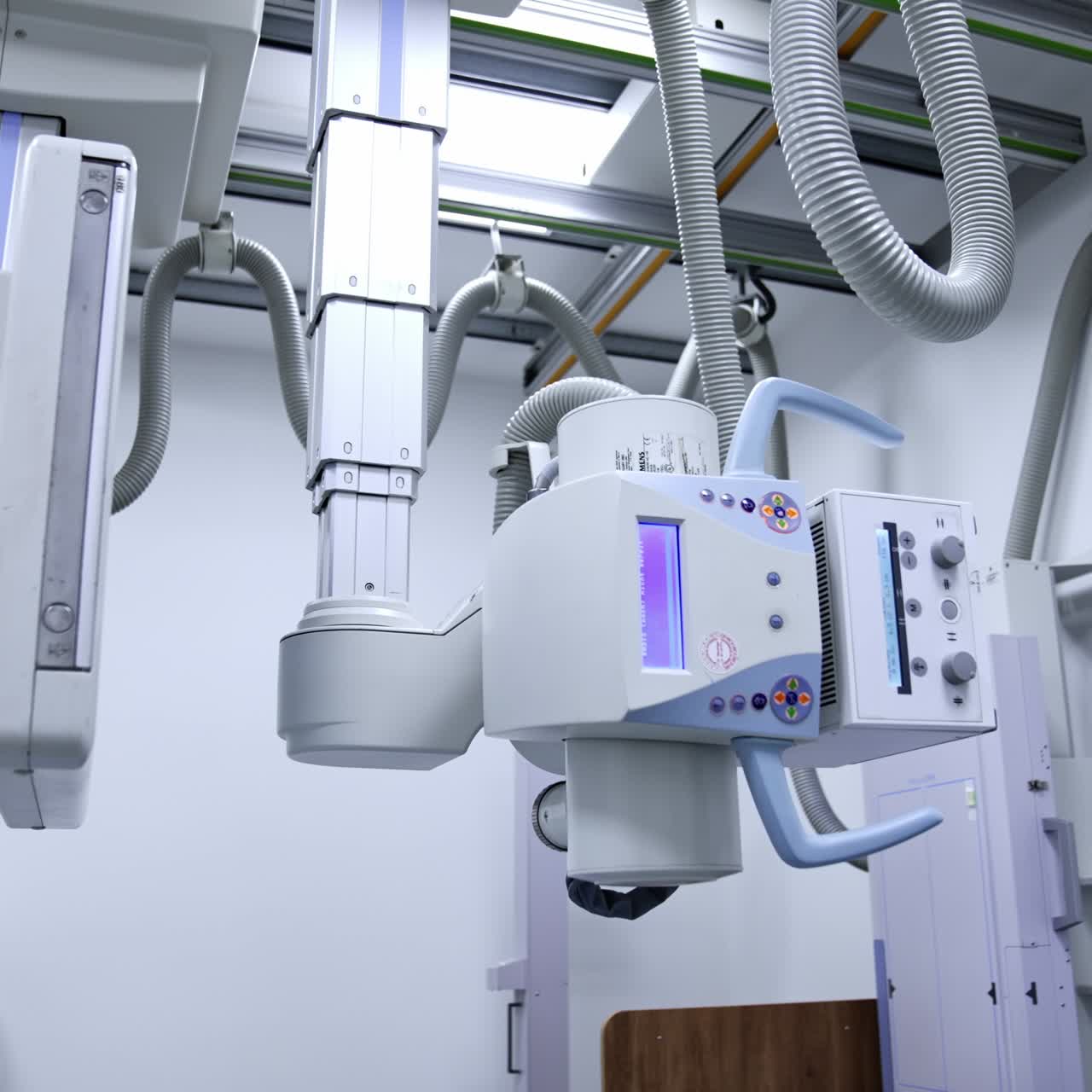 Advanced x-ray equipment in the modern hospital. Panning view of x-ray scan hanging on the ceiling of the radiology room. Low angle view