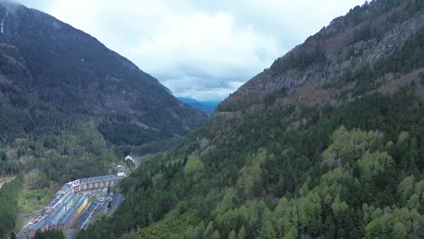 canfranc-estación, a historic railway station surrounded by mountains and forests, aerial view