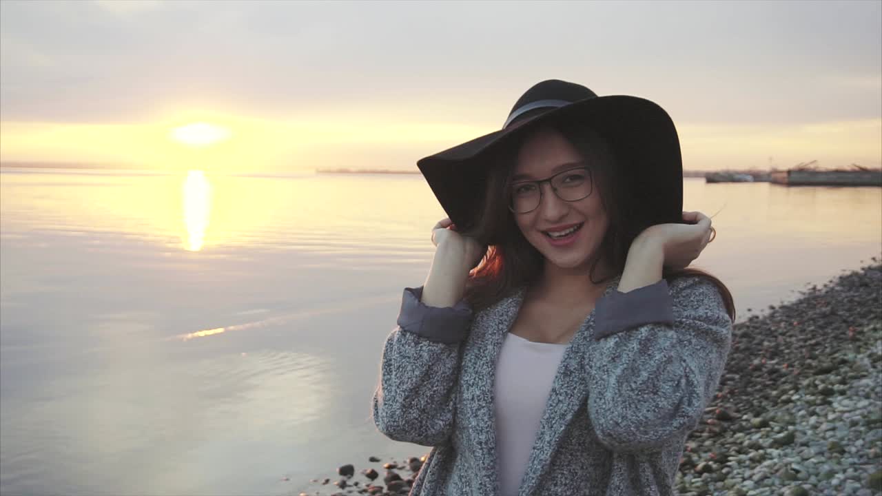 Woman enjoying sunset at the beach
