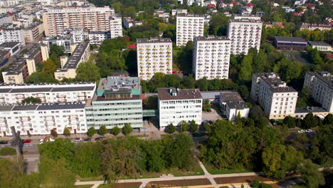 panning drone view of residential apartments amidst greenery