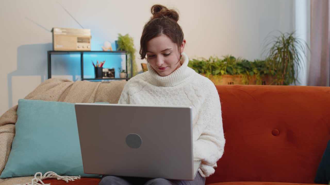 Pretty woman freelancer opens laptop starts working education sends messages makes online purchases