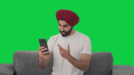 Happy-Sikh-Indian-man-talking-on-video-call-Green-screen