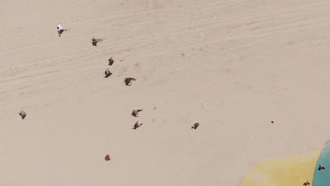 aerial view of men running in the beach