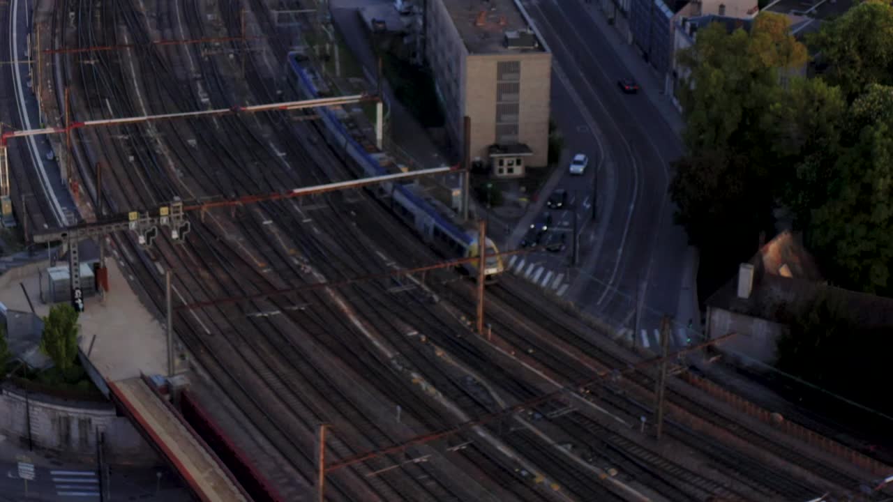 Drone tracking detail shot train on tracks entering station Stock HD 30p