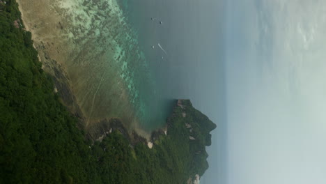 aerial view of a tropical island with clear waters and boats