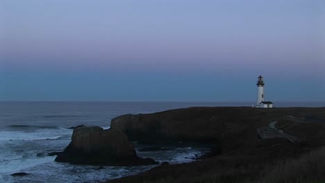 A-Lonely-Lighthouse-Stands-Guard-On-A-Rocky-Outcropping-Overlooking-A-Quiet-Sea