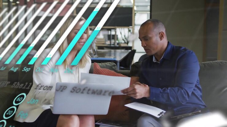 Man handing pages as woman using laptop, pointing, charts overlaying pages, driving business review