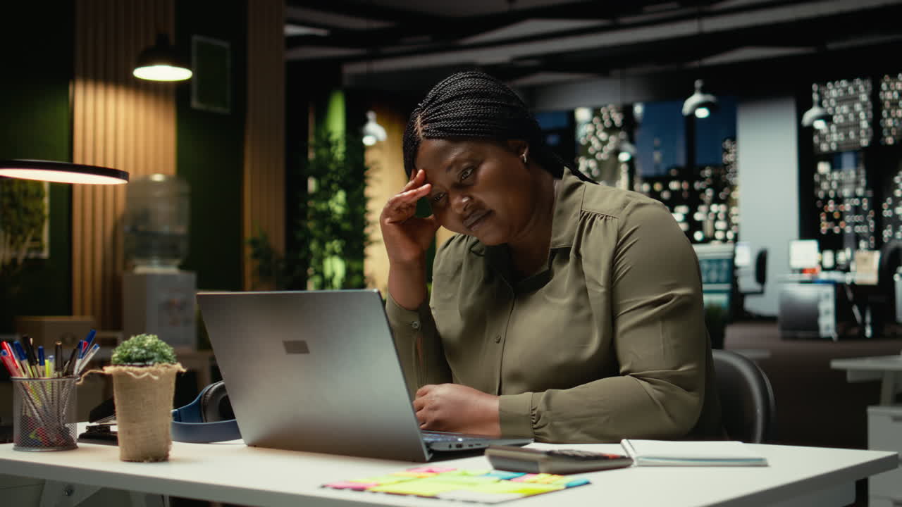 Female entrepreneur sighing being drained and overwhelmed after hours