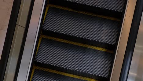 escalator steps going down in a building in bangkok, thailand