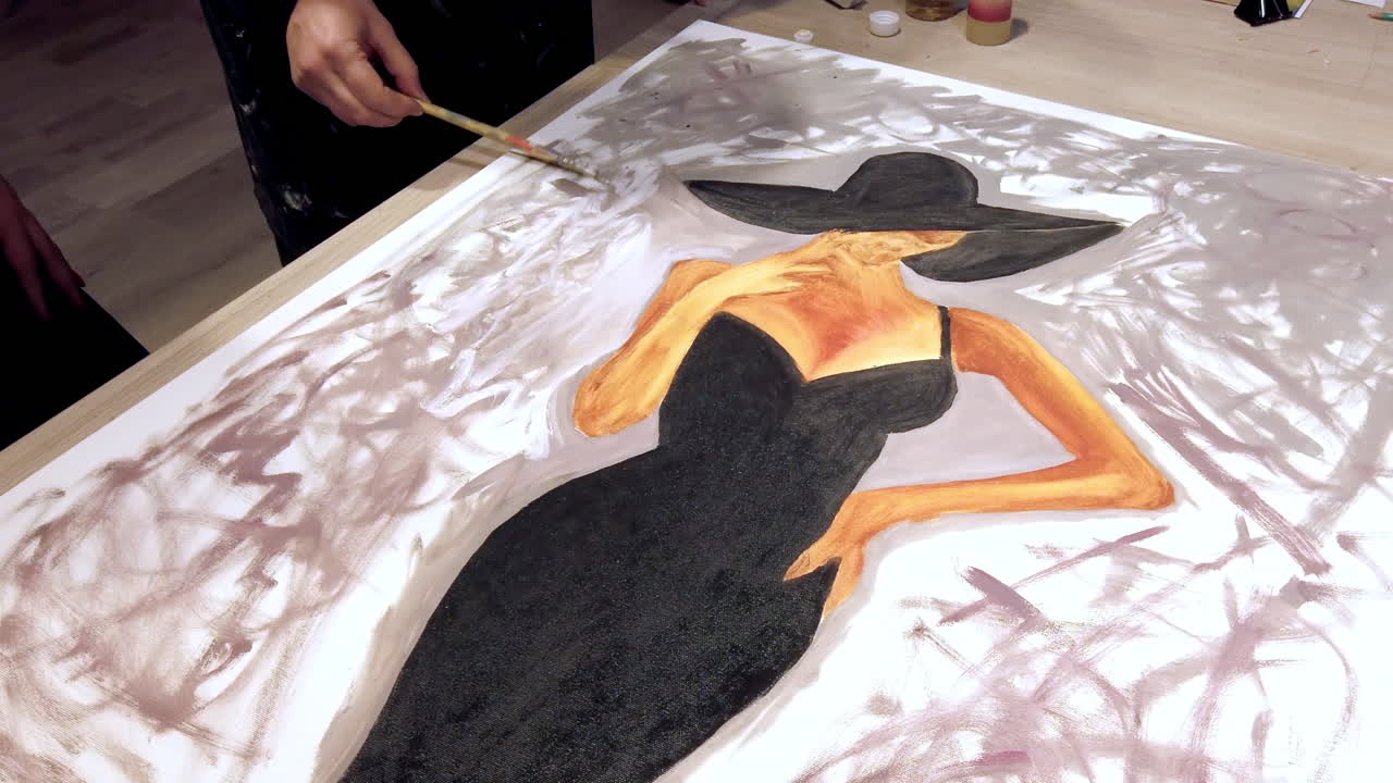 Woman paining on a paper at an art gallery workshop