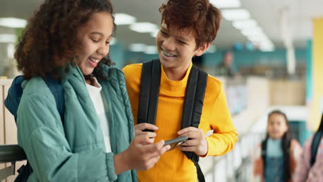 students looking at a phone at school