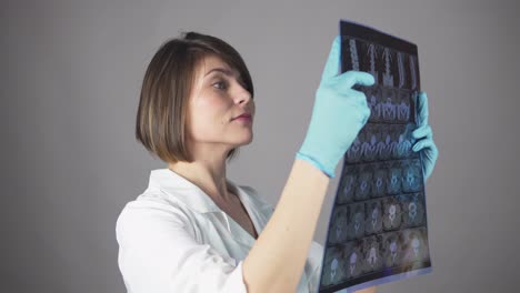 young female nurse reviewing x-rays isolated on white background. healthcare concept. shot in 4k