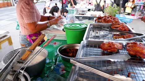 vendor cooking and serving fried chicken at market