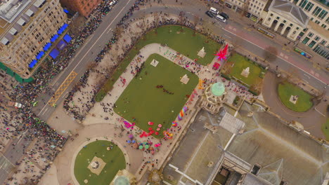 dynamic top-down aerial spin over st. patrick’s day performers and crowd at belfast city hall