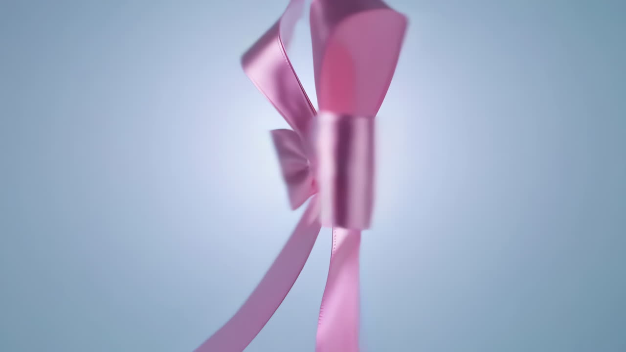 Elegant Pink Satin Bow with Glowing Center on a Gradient Background