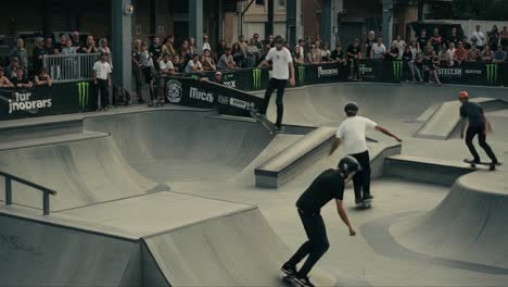 Exciting Skateboarding Action: Thrilling Moments from a Skate Park as Skateboarders Showcase Tricks in Front of Enthusiastic Crowd with Dynamic Flow and Skillful Moves