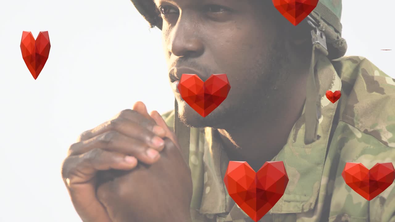 animación de los corazones cayendo sobre afroamericano soldado hombre orando