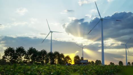 wind turbines standing in sunset. farm with wind turbines. generating clean renewable energy. bright orange sunset. alternative energy