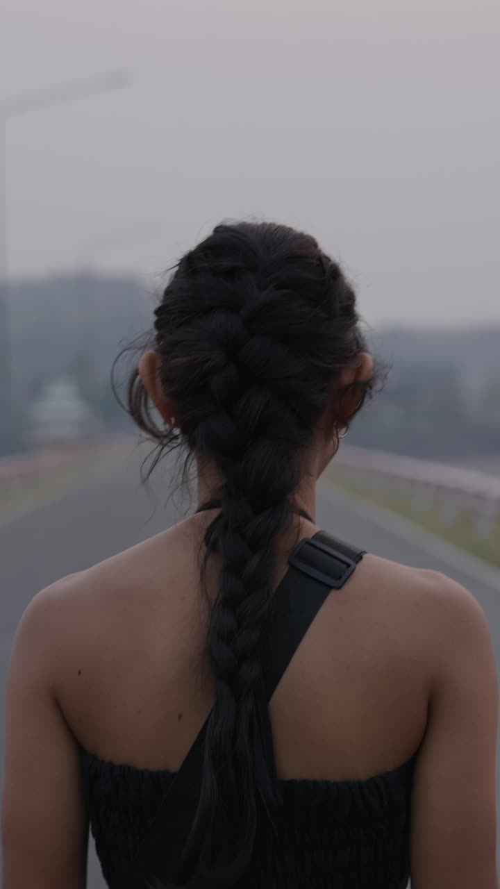 A woman with a braid on a road