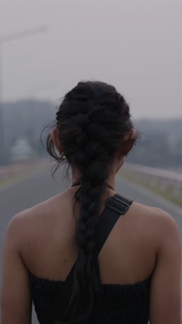 a woman with a braid on a road