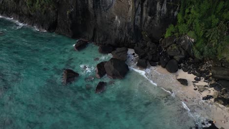 drone shot of secluded beach in comoros, azure waves lapping the shore