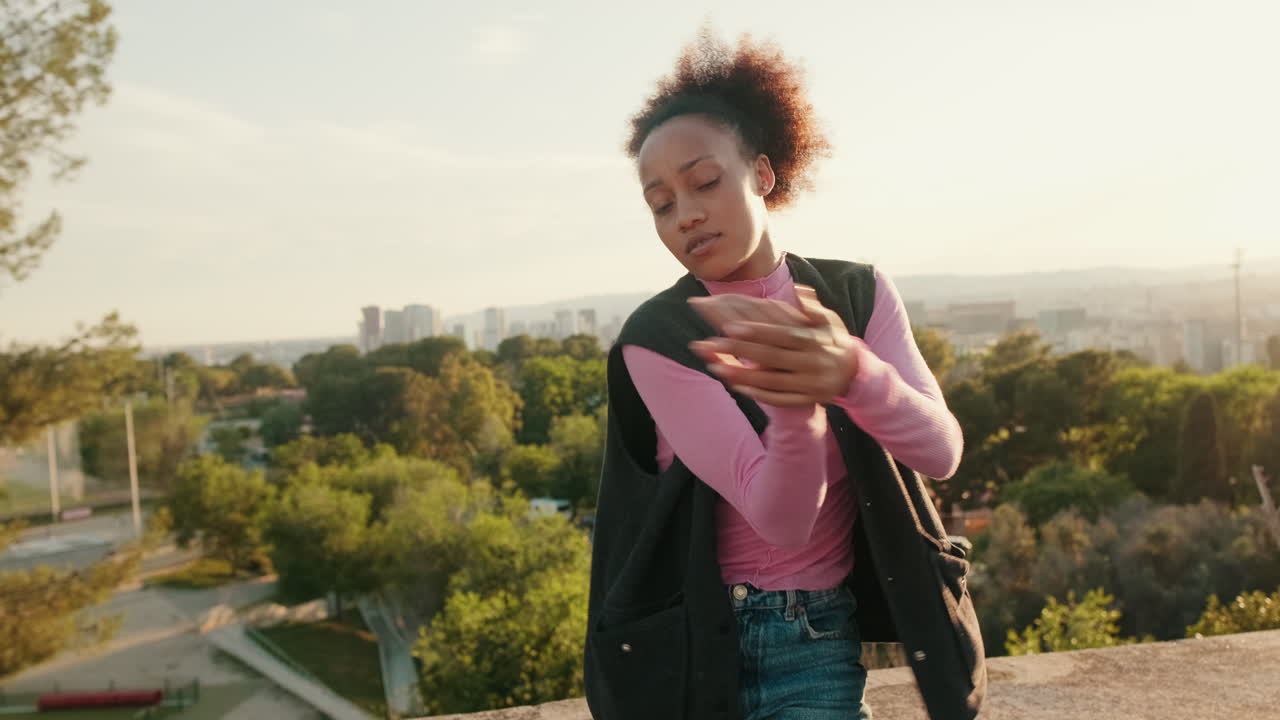 Young Woman Dances on Rooftop at Sunset